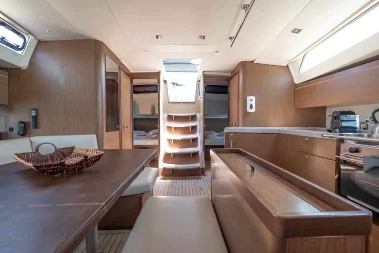 Beneteau Oceanis 46.1 - saloon interior, aft-facing view with a spacious seating area, for charter in Greece