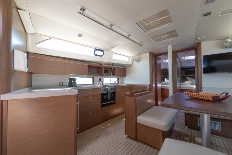 Beneteau Oceanis 46.1 - saloon interior with a galley, sailing yacht for charter in Greece.