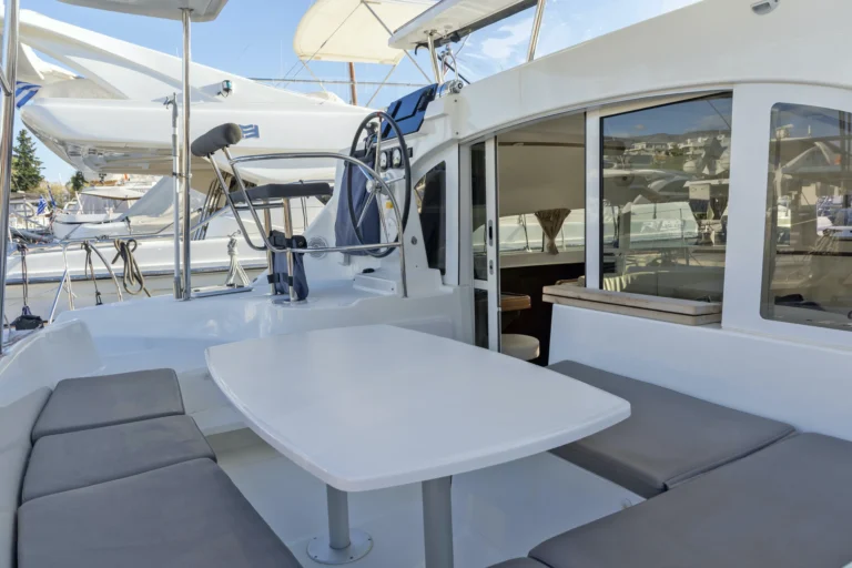 Lagoon 380 Tiny K cockpit with dining table, catamaran charter in Greece