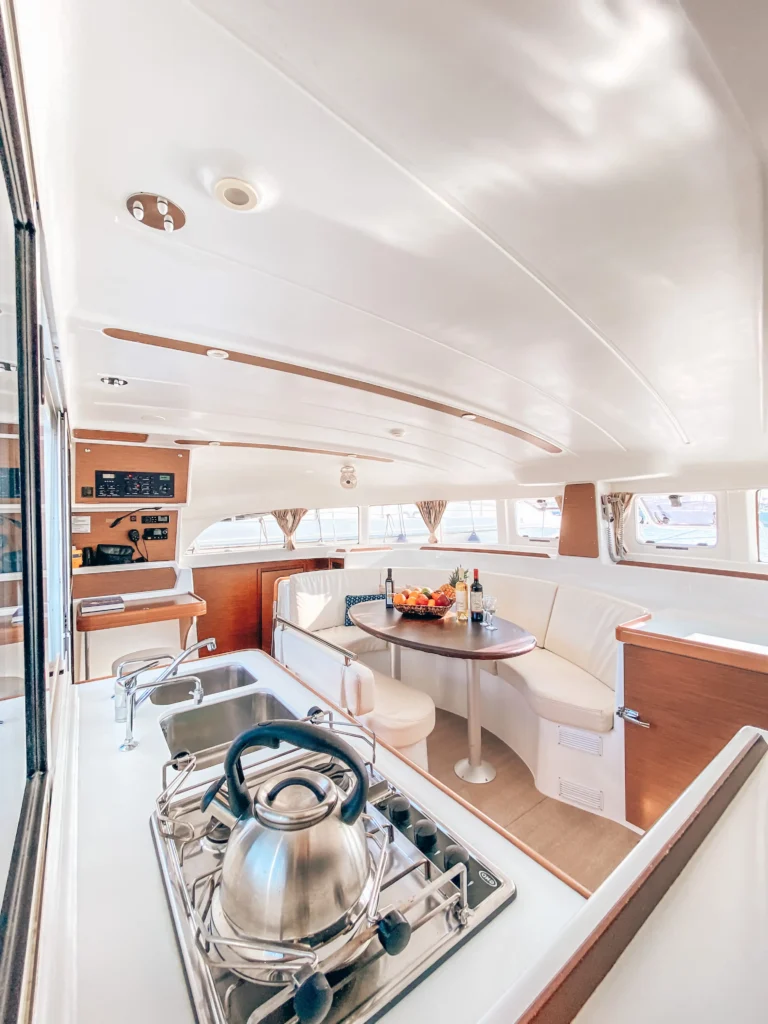 Lagoon 380 Tiny K interior saloon and galley front view, catamaran charter in Greece